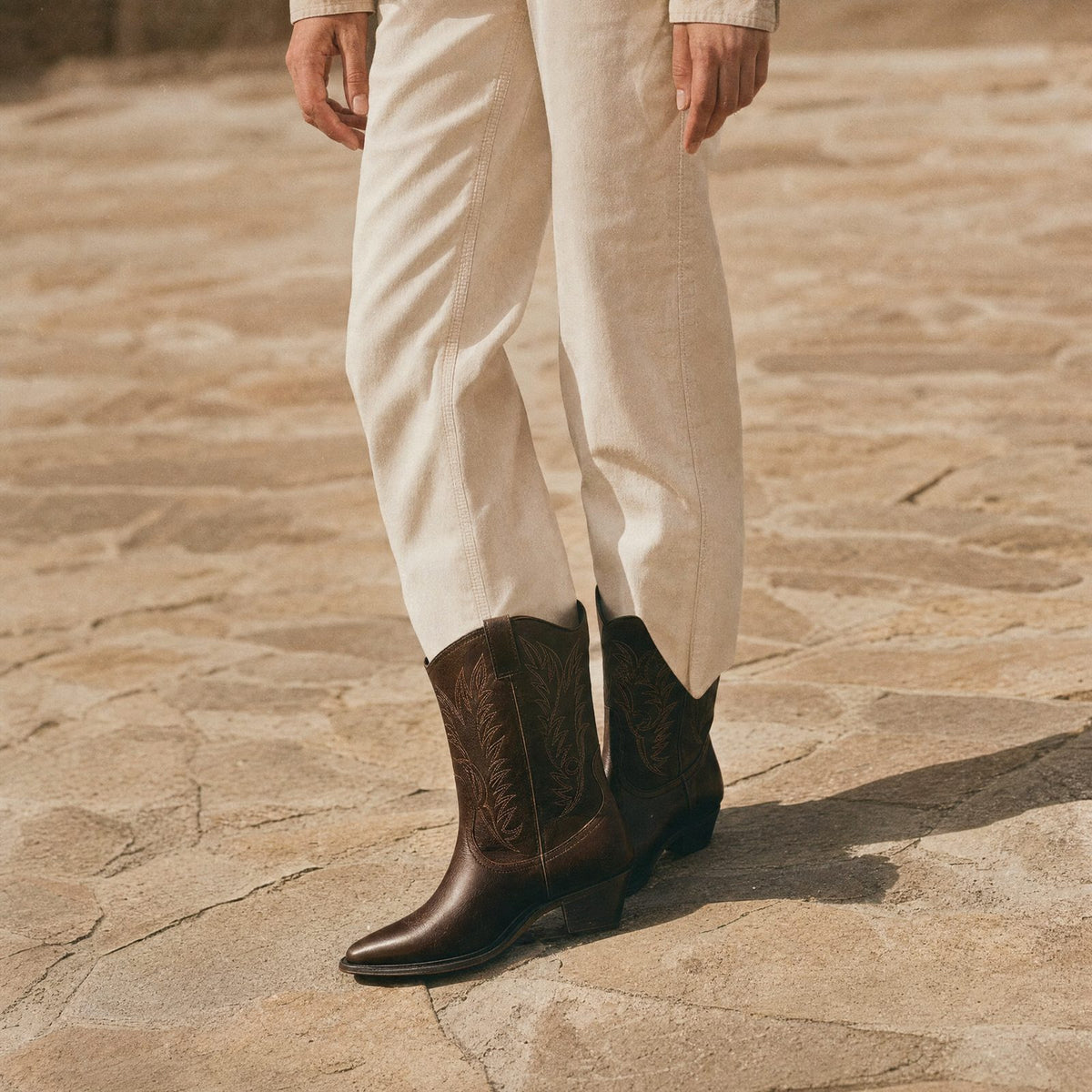 Mirazoe category tile: dark brown cowboy boots with cream trousers
